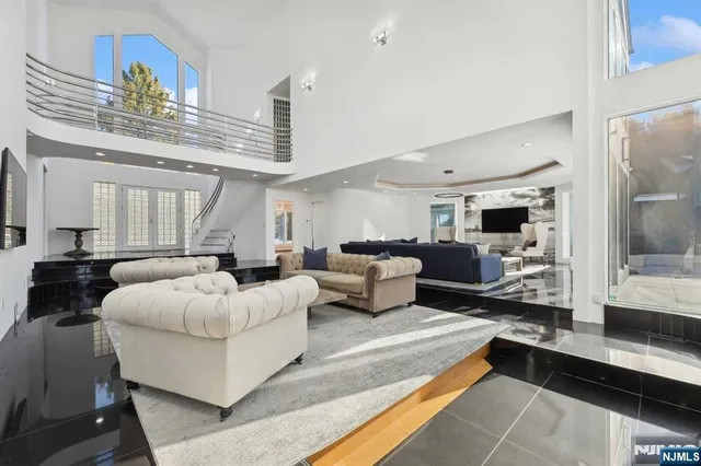 a living room with furniture and a chandelier