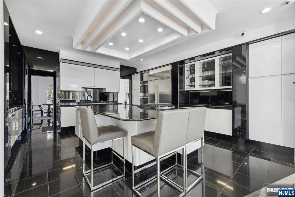 23 Rio Vista Drive Alpine, NJ 07620 - Photo 15 of 47 a kitchen with kitchen island a refrigerator and a dining table