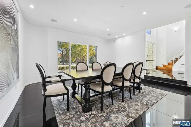 a view of a dining room with furniture and a rug