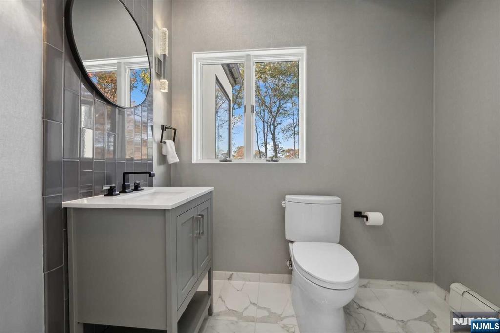 23 Rio Vista Drive Alpine, NJ 07620 - Photo 21 of 47 a bathroom with a toilet sink and mirror