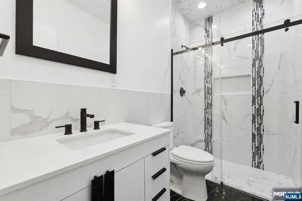 a bathroom with a sink toilet and shower