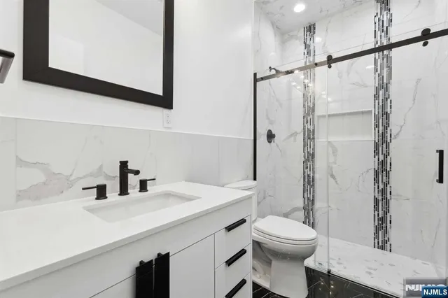 a bathroom with a sink toilet and shower