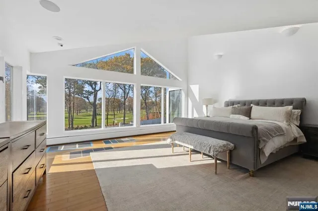 a spacious bedroom with a large bed and a large window