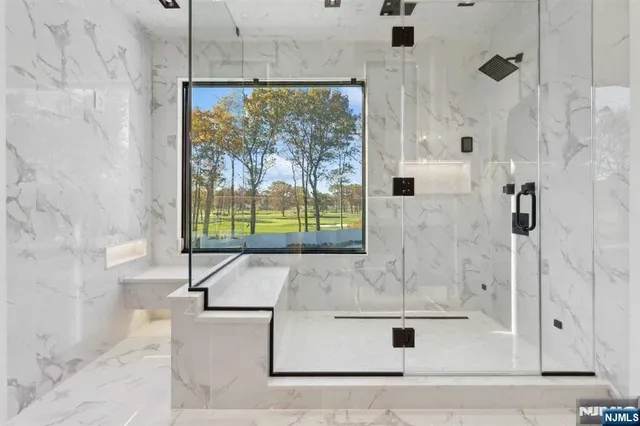 a bathroom with a bathtub and shower