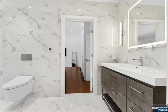 a spacious bathroom with a double vanity sink toilet and shower