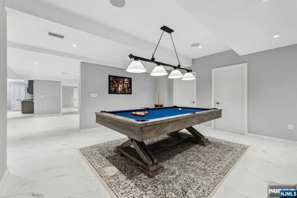 a living room with a table chairs and a table