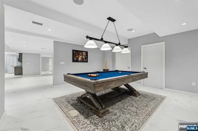 a living room with a table chairs and a table