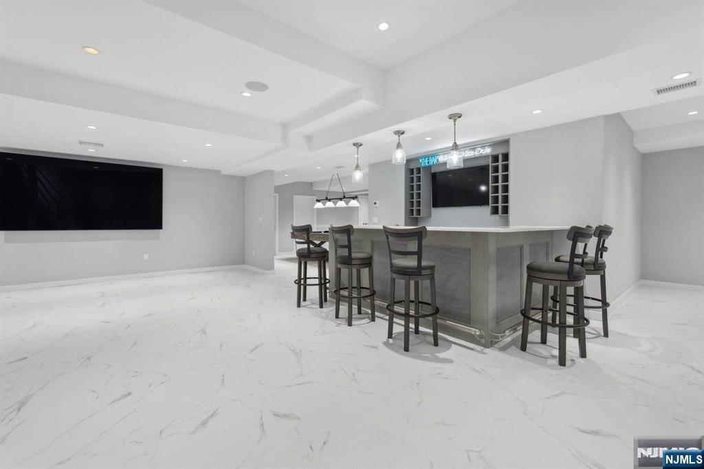 23 Rio Vista Drive Alpine, NJ 07620 - Photo 38 of 47 a living room with furniture and a flat screen tv