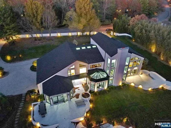 an aerial view of a house with yard swimming pool and outdoor seating