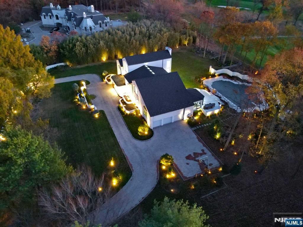 23 Rio Vista Drive Alpine, NJ 07620 - Photo 47 of 47 an aerial view of a house with a swimming pool a yard and a large tree