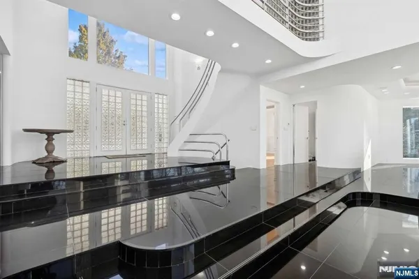 a large kitchen with stainless steel appliances a large counter top