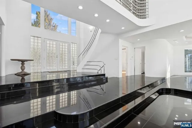 a large kitchen with stainless steel appliances a large counter top