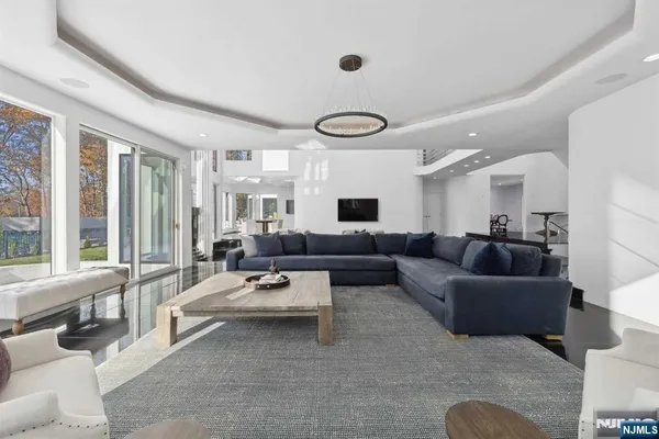 a living room with furniture and large windows