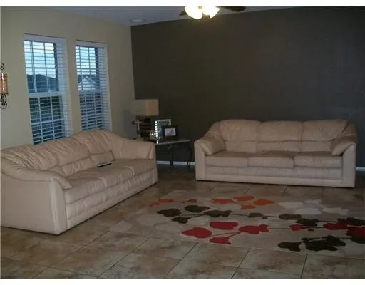 a living room with furniture and a rug