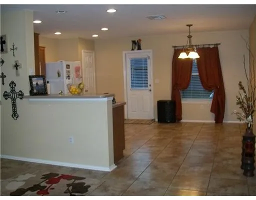 a view of a living room and kitchen with a sink