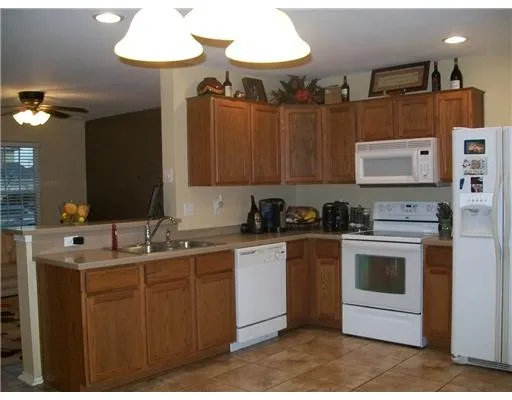 a kitchen with a sink a stove and cabinets