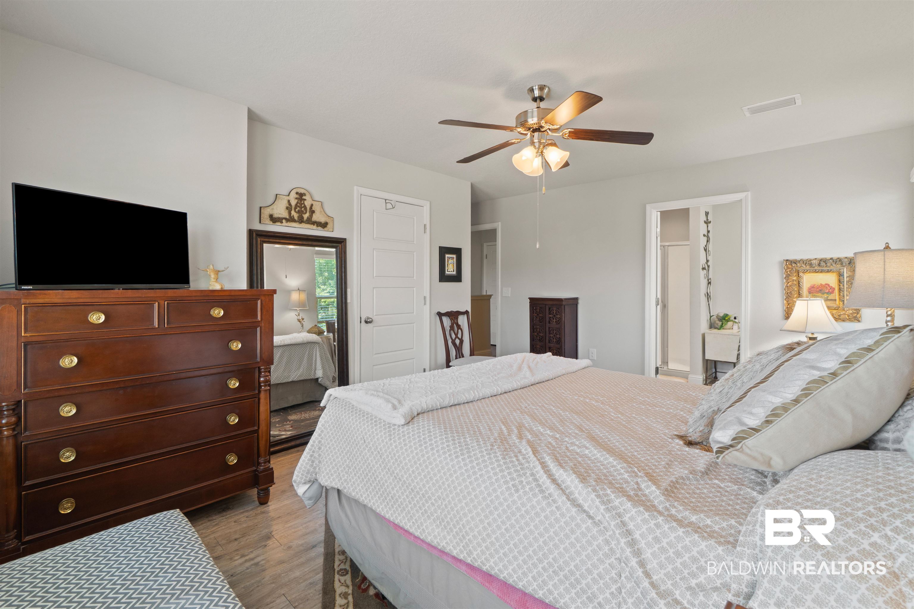 25806 Pollard Road, Unit 6 Daphne, AL 36526 - Photo 24 of 38 Spacious room featuring light gray walls and wood-finish flooring