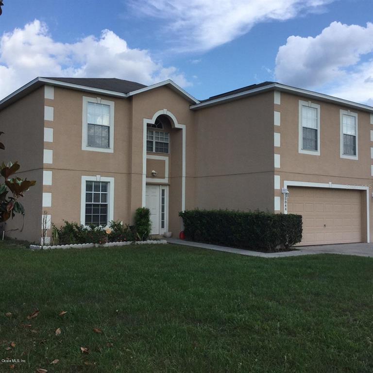 5844 Southwest 116th Pl Road Ocala, FL 34476 - Photo 1 of 1 a front view of a house with a garden