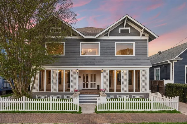 a living room with furniture a flat screen tv and kitchen view
