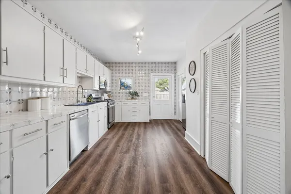 a view of empty room with wooden floor and window