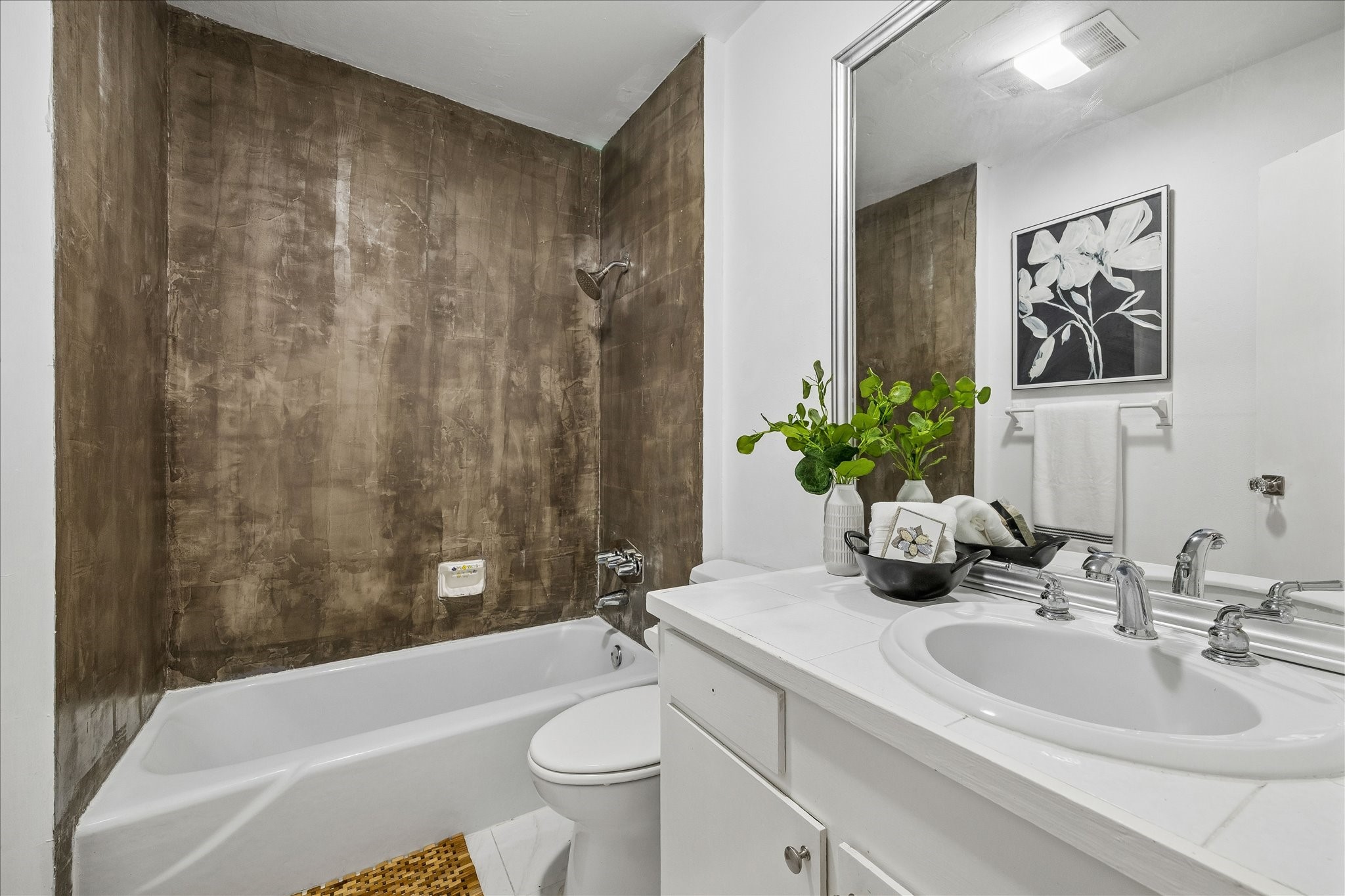 1812 Kane Street Houston, TX 77007 - Photo 19 of 41 a bathroom with a sink a toilet a mirror a bathtub and shower