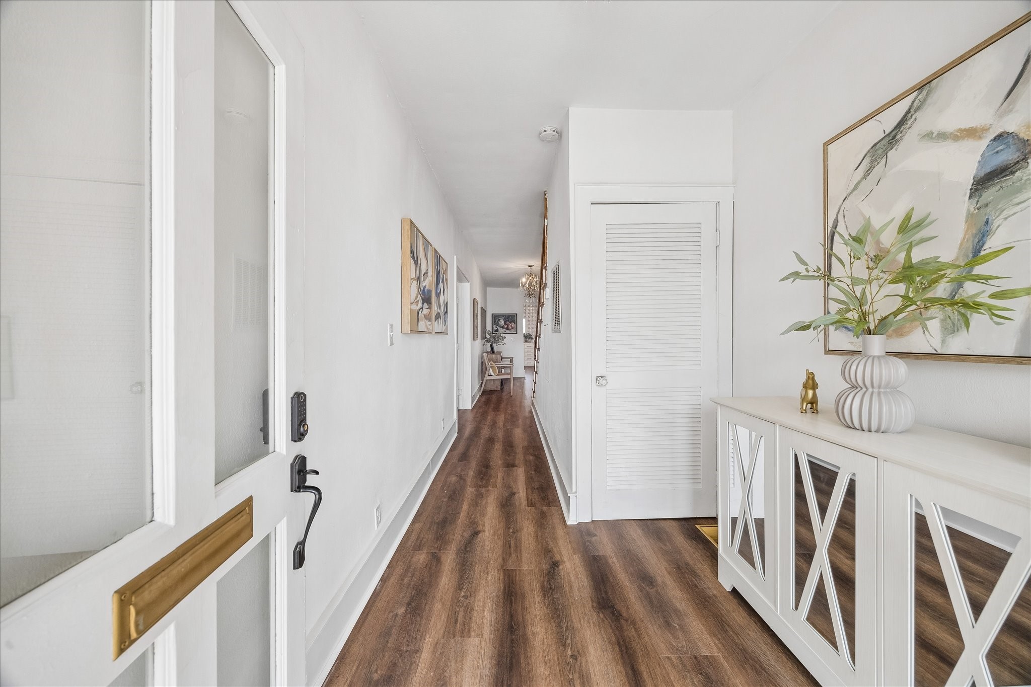1812 Kane Street Houston, TX 77007 - Photo 7 of 41 a view of a hallway to a livingroom with wooden floor and stairs