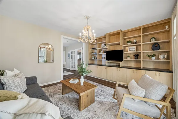 a kitchen with granite countertop a stove top oven a sink dishwasher and a refrigerator with wooden floor