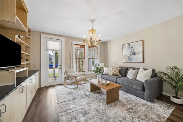 a spacious bedroom with a bed and a chandelier