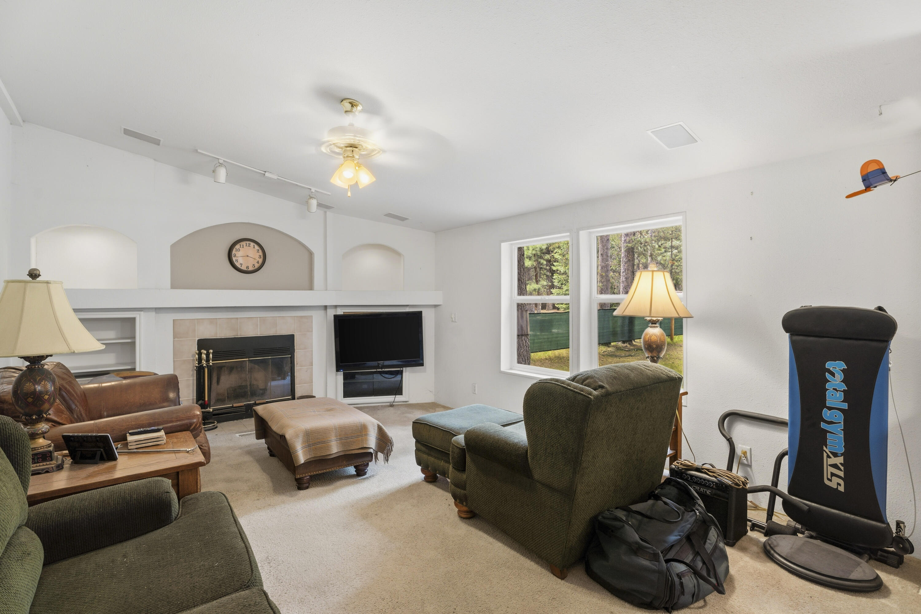 16928 Covina Road Bend, OR 97707 - Photo 7 of 48 a living room with furniture a fireplace and a flat screen tv