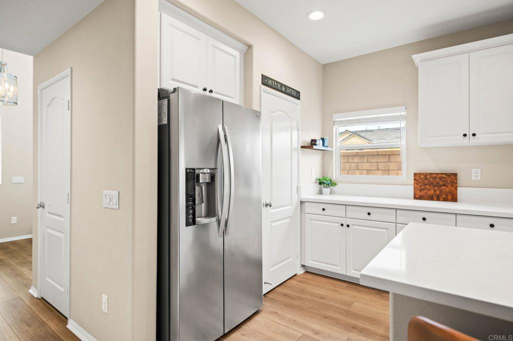 35846 Esperia Way Fallbrook, CA 92028 - Photo 12 of 60 a kitchen with stainless steel appliances a refrigerator sink and cabinets
