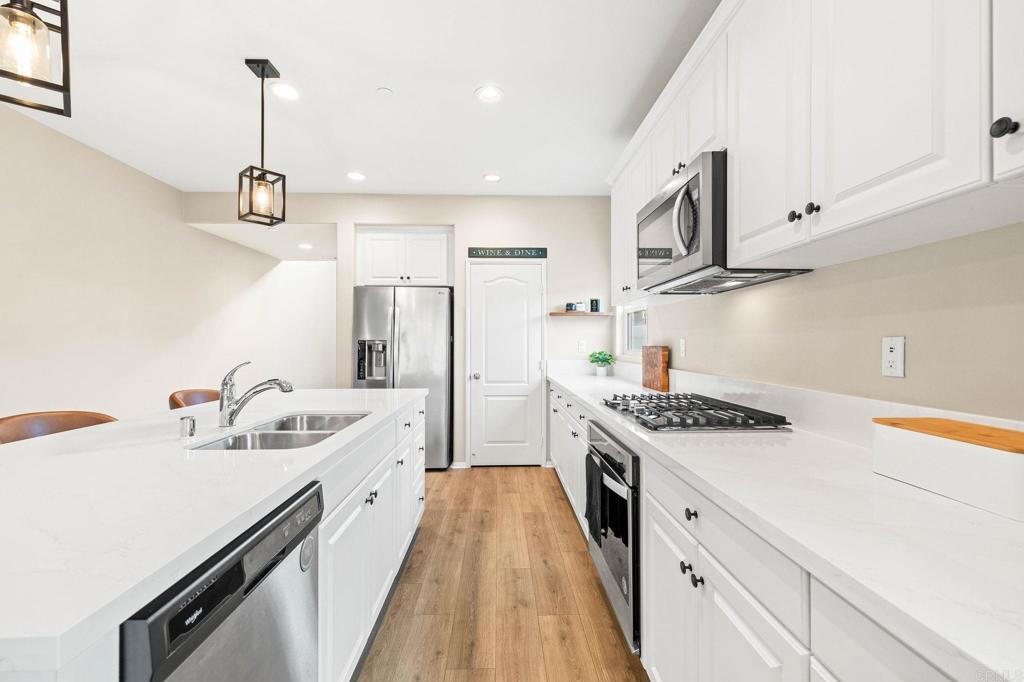 35846 Esperia Way Fallbrook, CA 92028 - Photo 14 of 60 a kitchen with stainless steel appliances a sink stove and refrigerator