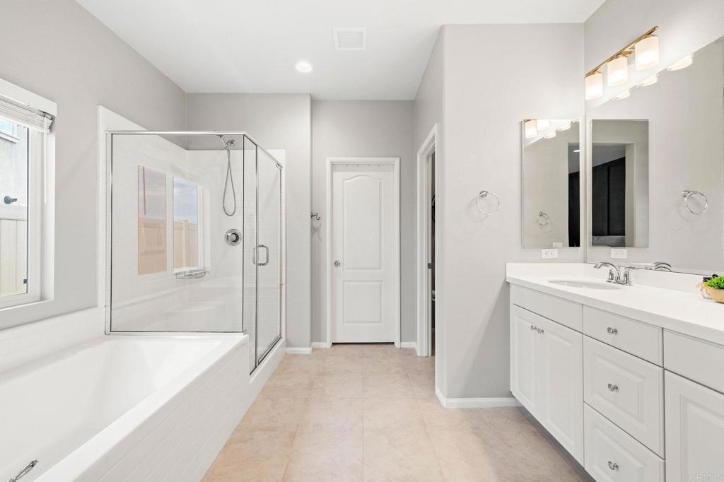 35846 Esperia Way Fallbrook, CA 92028 - Photo 27 of 60 a bathroom with a tub sink and mirror