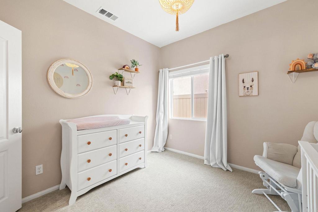 35846 Esperia Way Fallbrook, CA 92028 - Photo 33 of 60 a view of a bedroom with furniture and wooden floor