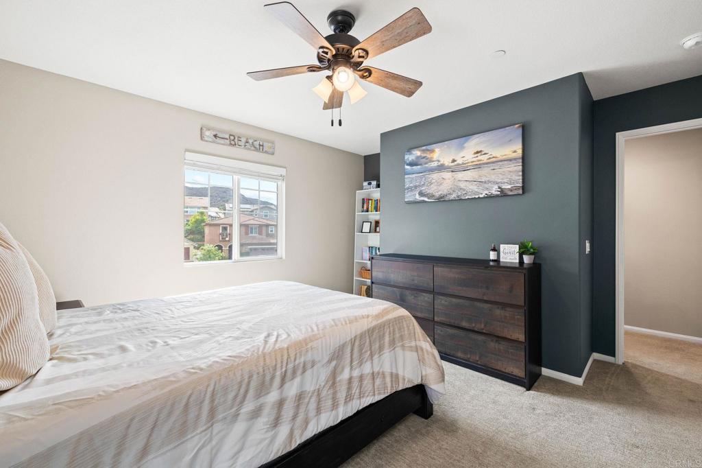 35846 Esperia Way Fallbrook, CA 92028 - Photo 42 of 60 a bedroom with a bed and a chandelier