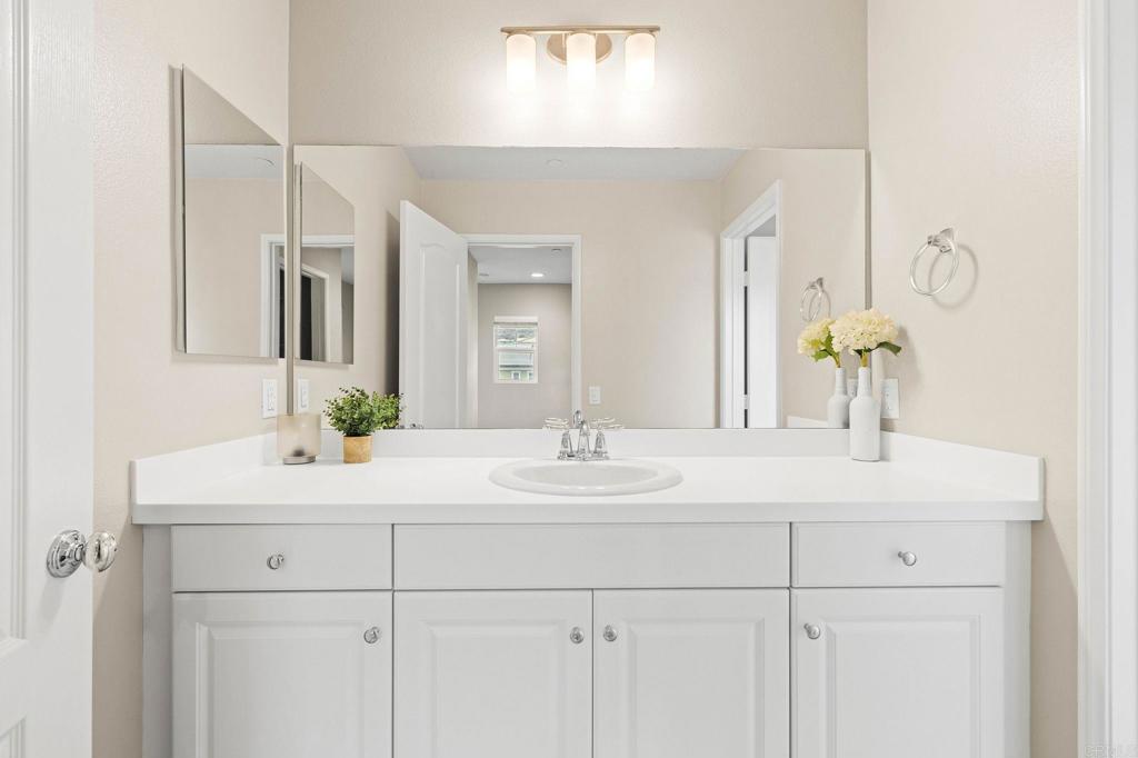 35846 Esperia Way Fallbrook, CA 92028 - Photo 45 of 60 a bathroom with a sink and a mirror