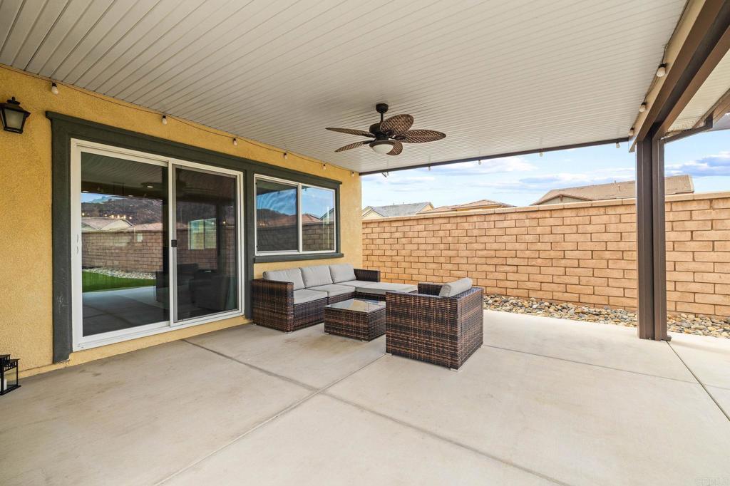 35846 Esperia Way Fallbrook, CA 92028 - Photo 52 of 60 a living room with couch next to a large window with outer view