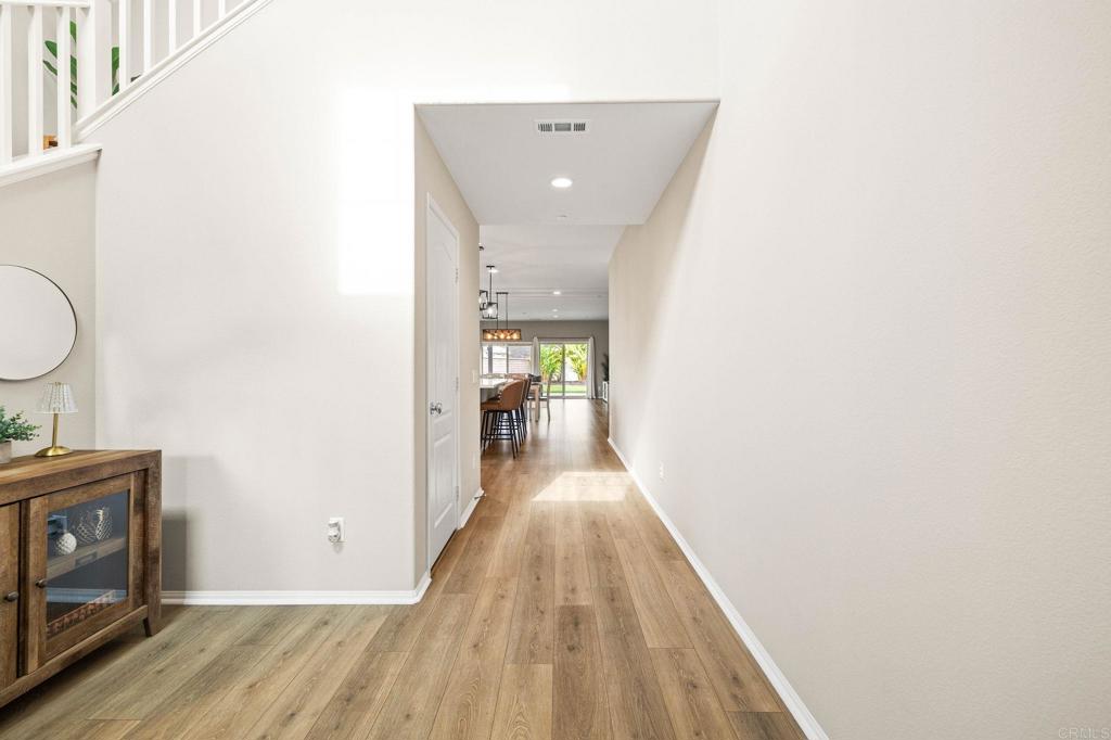 35846 Esperia Way Fallbrook, CA 92028 - Photo 9 of 60 a view of a hallway with wooden floor and a bathroom