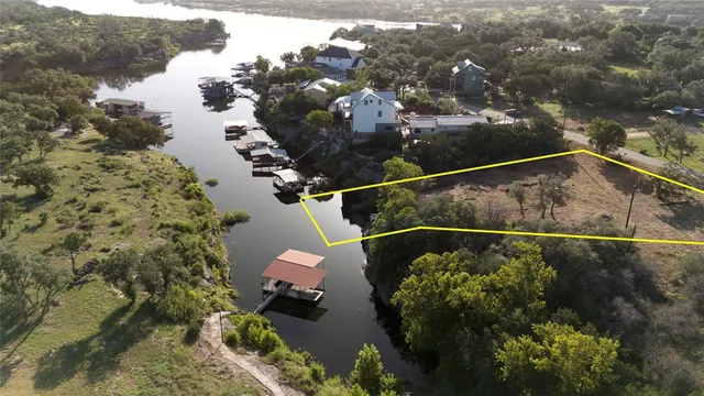 an aerial view of house with yard and mountain view in back