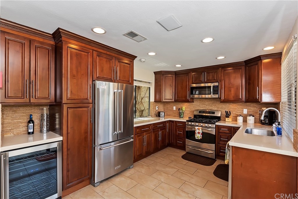 109 Torremolinos Drive Rancho Mirage, CA 92270 - Photo 14 of 33 a kitchen with stainless steel appliances granite countertop a refrigerator stove microwave and sink