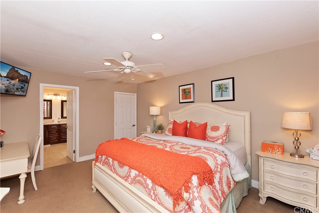 109 Torremolinos Drive Rancho Mirage, CA 92270 - Photo 22 of 33 a spacious bedroom with a bed and a lamp with window