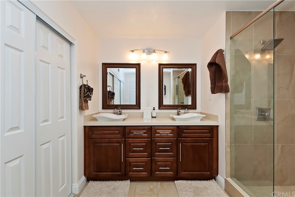 109 Torremolinos Drive Rancho Mirage, CA 92270 - Photo 23 of 33 a bathroom with a double vanity sink and a mirror