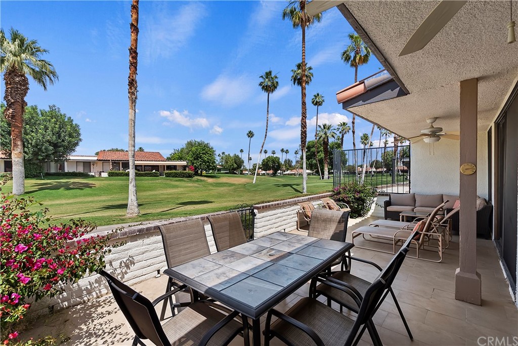 109 Torremolinos Drive Rancho Mirage, CA 92270 - Photo 28 of 33 a view of a patio with table and chairs potted plants and palm tree