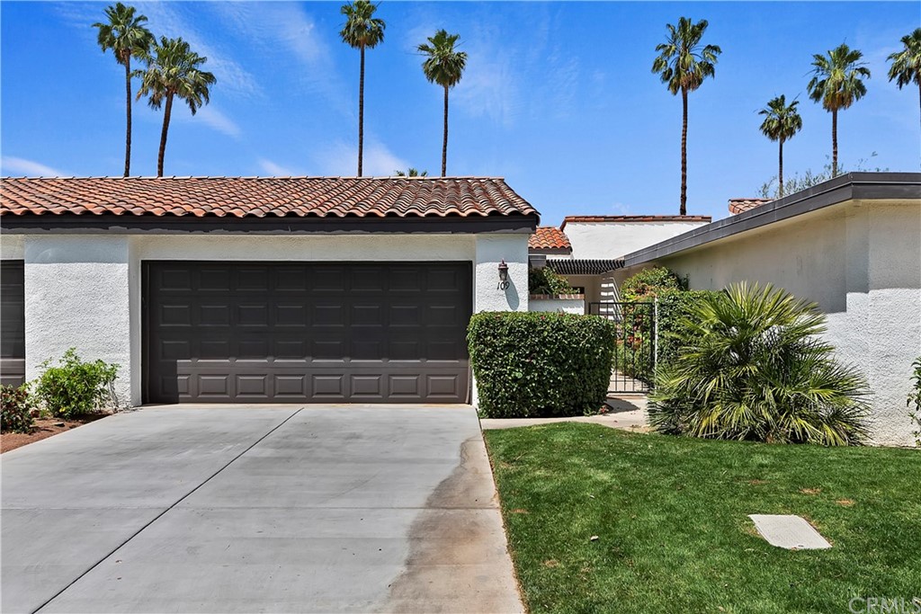 109 Torremolinos Drive Rancho Mirage, CA 92270 - Photo 4 of 33 a front view of a house with a yard