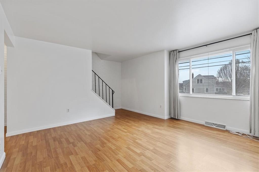 78 Seavey Road Pittsburgh, PA 15223 - Photo 5 of 29 A large window and wood grain laminate flooring create a light and bright living room.