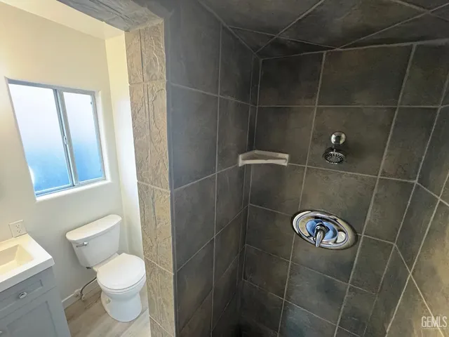 a bathroom with a toilet and a shower