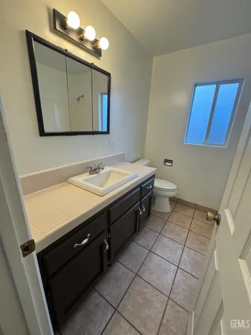 a bathroom with a sink vanity and a mirror