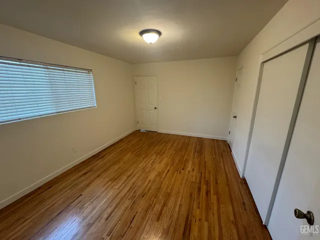a view of a room with wooden floor and staircase