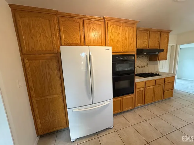a white refrigerator freezer sitting in a kitchen