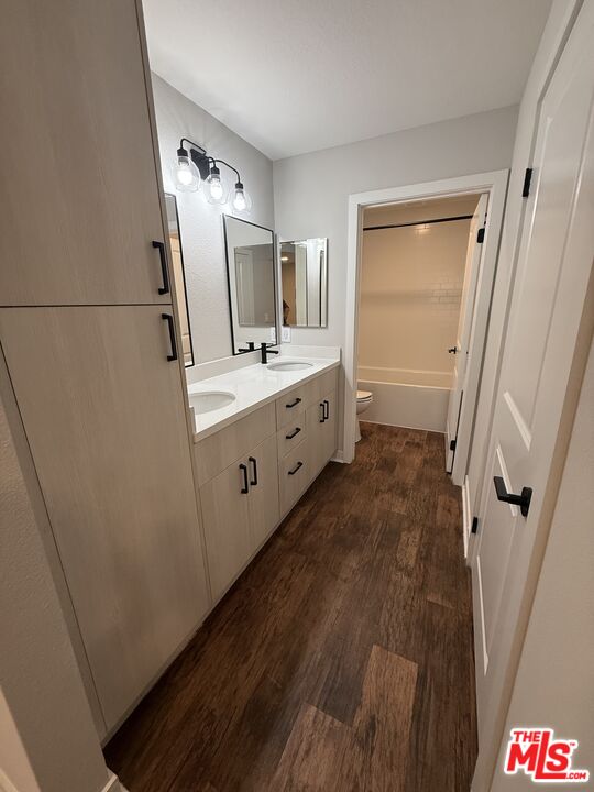 7660 Beverly Boulevard, Unit 237 Los Angeles, CA 90036 - Photo 4 of 7 a bathroom with a sink a mirror and a toilet