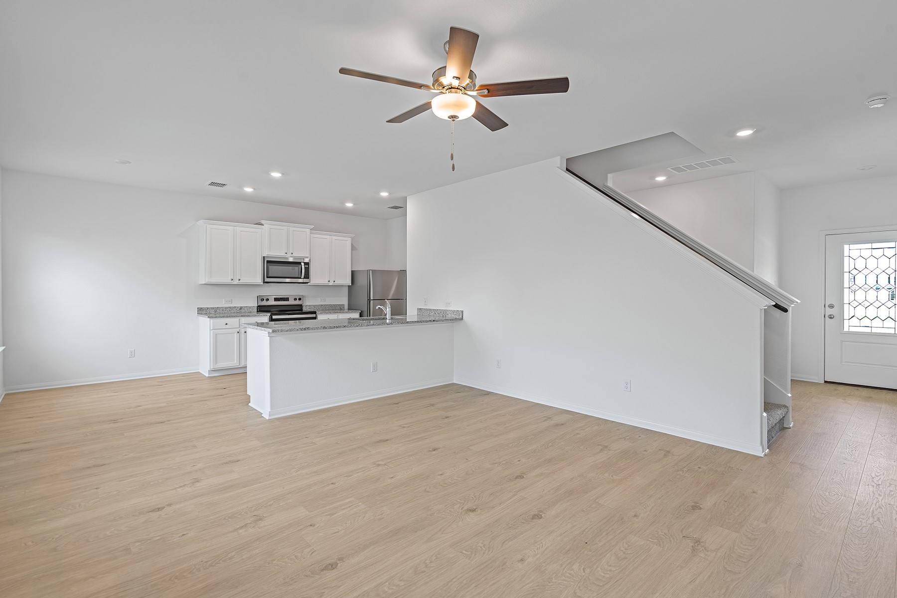 14524 Wahlbergs Way Elgin, TX 78621 - Photo 2 of 12 a view of kitchen with kitchen island stainless steel appliances refrigerator stove top oven and cabinets